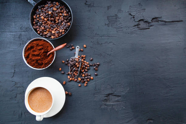 istock Roasted coffee beans with coffee powder and coffee cups. 1266959953