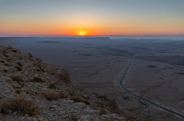 nascer do sol sobre o deserto judaico. vista do topo do penhasco perto de mitzpe ramon em israel - horizon over land israel tree sunrise - fotografias e filmes do acervo