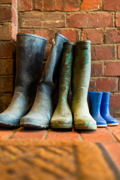 Dirty family gumboots by front door