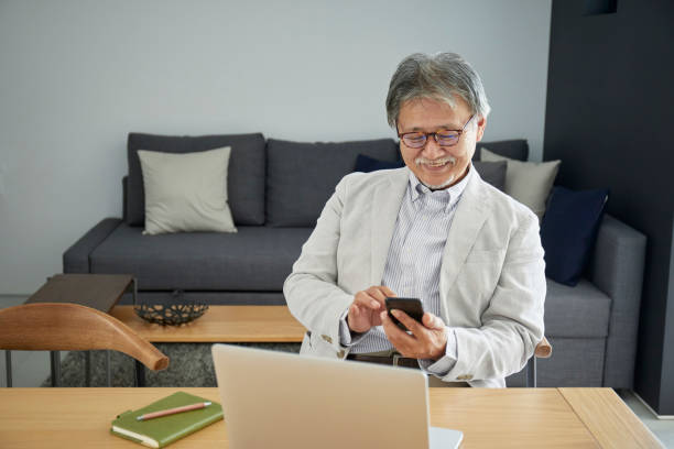 istock Senior man using smartphone in the room 1266962926
