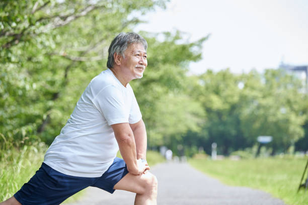 Senior man stretching outdoors