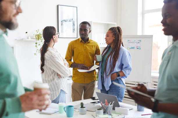 istock Business Team Chatting at Coffee Break in Office 1266963435