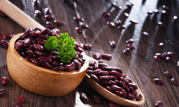istock Composition with bowl of kidney bean on wooden table 1266964265