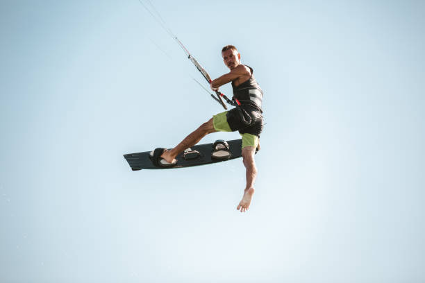 istock Kitesurfing Kiteboarding action photos man among waves quickly goes 1266965522