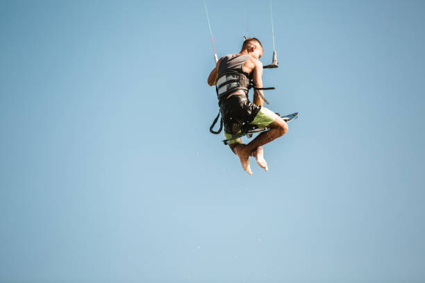 istock Kitesurfing Kiteboarding action photos man among waves quickly goes 1266965673