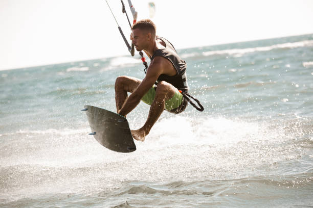 istock Kitesurfing Kiteboarding action photos man among waves quickly goes 1266967551