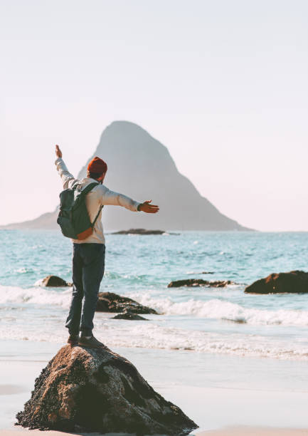 istock Man explorer enjoying sea view on empty beach traveling in Norway active vacations outdoor lifestyle adventure trip escape 1266968036