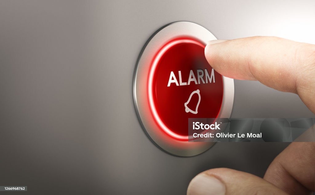 Man pressing a red security alarm button. Finger pressing a red alarm button. Warning concept. Composite image between a hand photography and a 3D background. Alarm Stock Photo