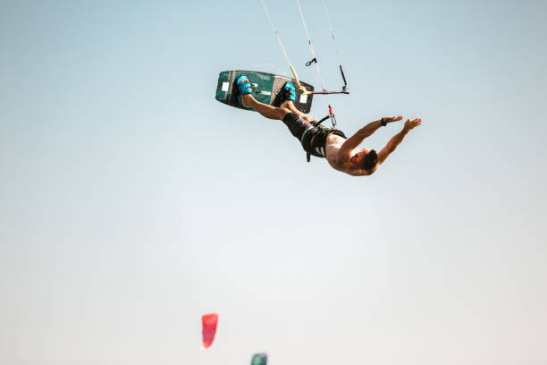 istock Kitesurfing Kiteboarding action photos man among waves quickly goes 1266970119