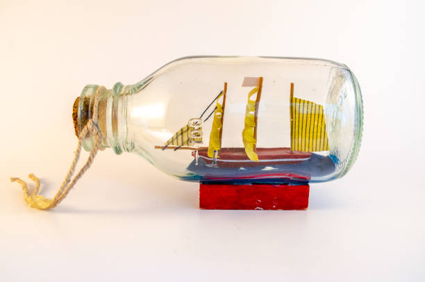 istock Sailingboat in a bottle isolated on white 1266971999