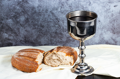 holy communion chalice with wine and bread.