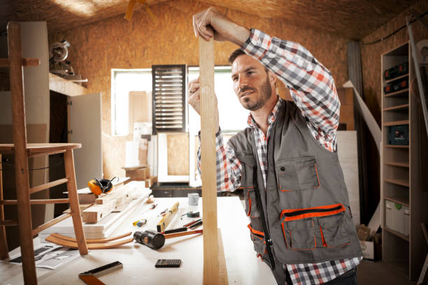 istock Carpenter making measurements on a plank of wood 1266972812