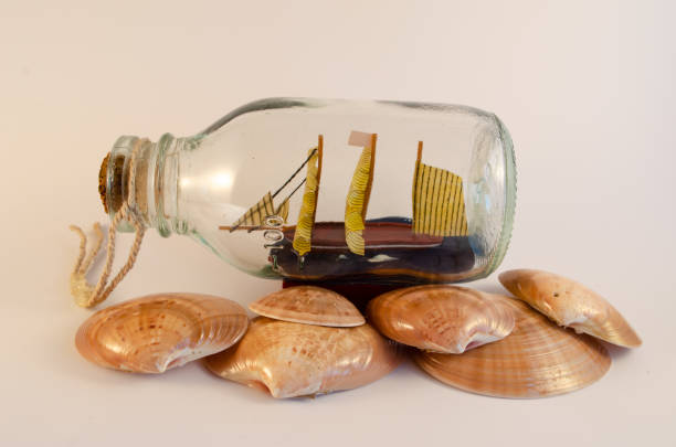istock Sailingboat in a bottle isolated on white 1266972883