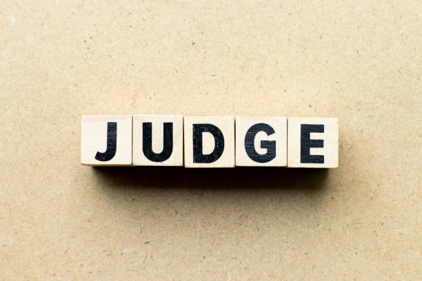 istock Letter block in word judge on wood background 1266972927