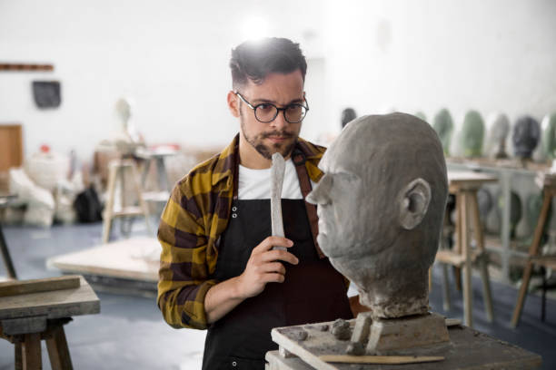 istock Male Sculptor working on a clay bust 1266973514