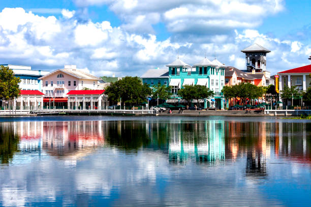 Reflections on the water highlight a Lakeside View and the unique Downtown Shopping and Restaurant area of Celebration, Florida. stock photo