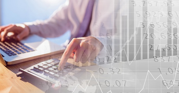 Digital illustration of a person using a calculator and a laptop over statistics and graph showing. Finance business stock market global data processing concept digitally generated image