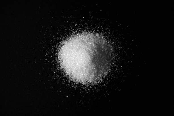 istock Scattered sugar in a pile and refined sugar cubes on a black background 1266978679