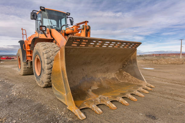 istock Excavator at the construction site of a road, moving earth 1266978722