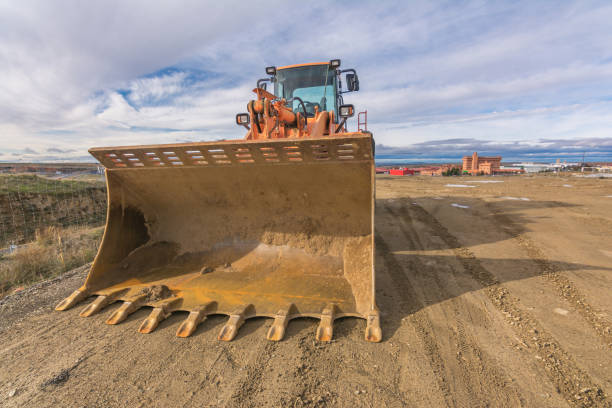 istock Excavator at the construction site of a road, moving earth 1266978729