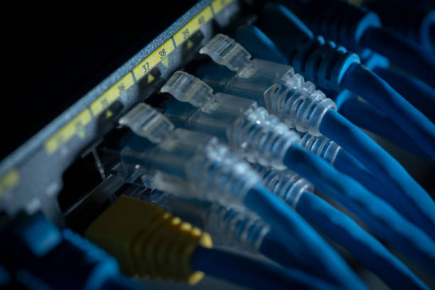 istock Network cable and Gigabit Switch port or LAN UTP cat6 cable in technology data center room. Close up and selective focus. 1266980736