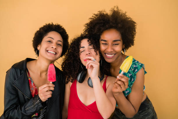 istock Multi-ethnic group of friends enjoying summertime while eating ice cream. 1266980741