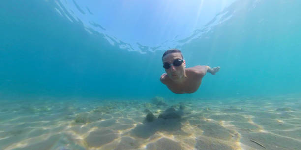 istock Man diving to sea bottom 1266983001