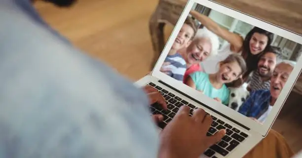 Photo of Family having video call on laptop