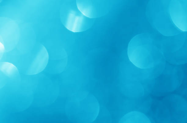 istock glitter light sparkle blue gorgeous bokeh defocused abstract background shiny. 1266986591