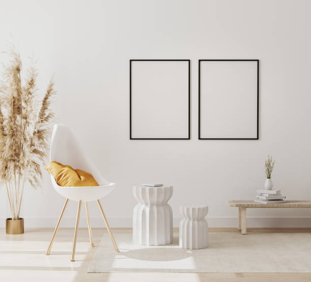 istock blank poster frames mockup in modern interior background with empty white wall, chair and pampas grass, luxury living room interior background, scandinavian style, 3d rendering 1266987533