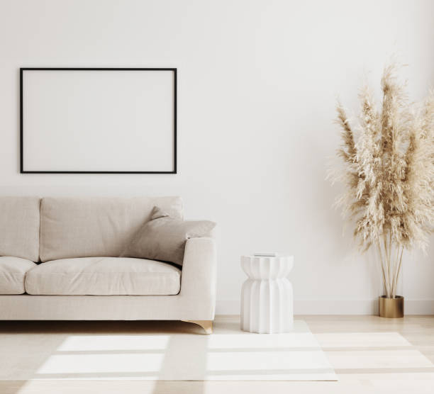 istock Empty horizontal poster frame mock up in modern living room interior background in biege colours, sofa with coffee table and dried flowers on wooden floor, scandinavian style, 3d rendering 1266987535