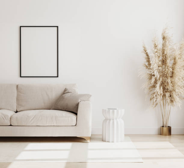 istock Empty Poster frame mock up  in modern living room interior background in biege colours, sofa with coffee table and dried flowers on wooden floor, scandinavian style, 3d rendering 1266987539