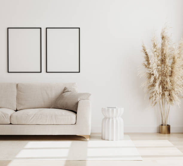 istock Empty Poster frame mock up  in modern living room interior background in biege colours, sofa with coffee table and dried flowers on wooden floor, scandinavian style, 3d rendering 1266987547