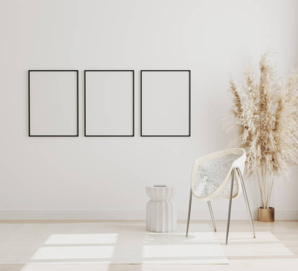 istock Blank vertical poster frames mock up on white wall in modern interior background with chair and pampas grass on wooden floor, scandinavian style, 3d rendering 1266987550
