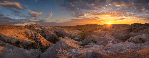 South Dakota Sunset Panorama Stunning view of a colorful summer sunset in Badlands National Park badlands stock pictures, royalty-free photos & images