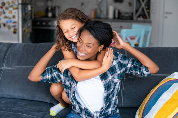 istock Affectionate mother and daughter embracing at home. 1266987886