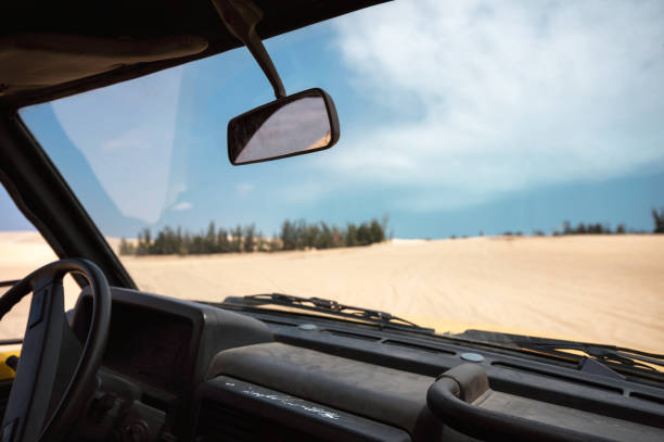 istock Inside of Four-wheel car driving on desert 1266988761