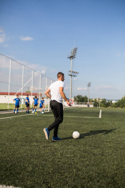 istock Coach and Young Footballers 1266990602