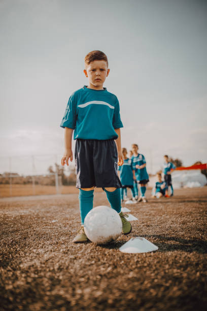 istock Boy in children's soccer team on training 1266992036