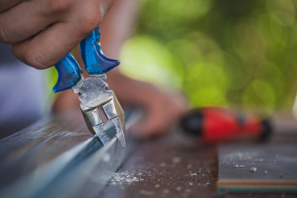 istock Man working with pliers like carpenter in his backyard 1266992149