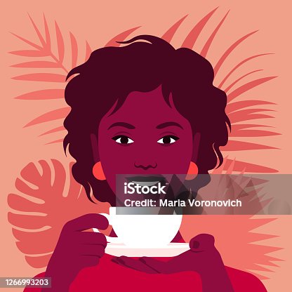 istock An African woman is holding a cup of tea or coffee. Happy breakfast. 1266993203