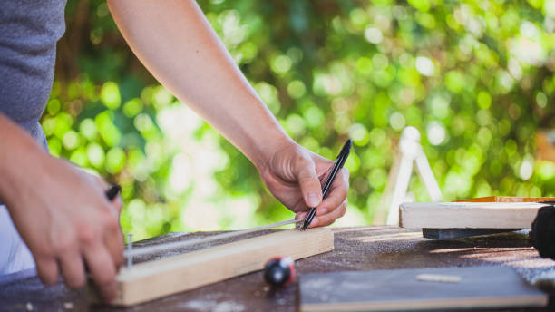 istock Man working like carpenter in his backyard during lockdown 1266993212
