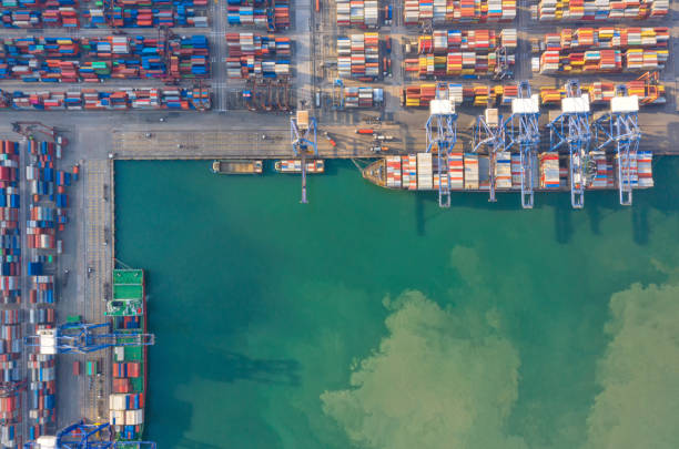 istock Container , container ship in export and import business and logistics. Shipping cargo to harbor by crane. Water transport International. Aerial view and top view. 1266993328