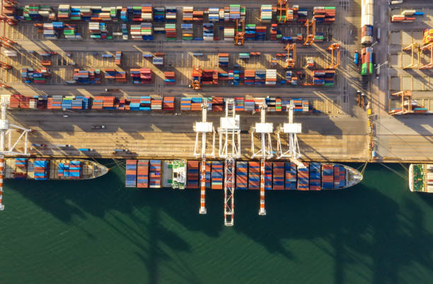 istock Container , container ship in export and import business and logistics. Shipping cargo to harbor by crane. Water transport International. Aerial view and top view. 1266993329