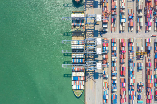 istock Container , container ship in export and import business and logistics. Shipping cargo to harbor by crane. Water transport International. Aerial view and top view. 1266993335