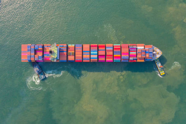 istock Container , container ship in export and import business and logistics. Shipping cargo to harbor by crane. Water transport International. Aerial view and top view. 1266993336