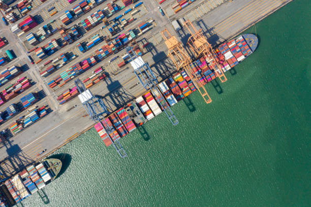 istock Container , container ship in export and import business and logistics. Shipping cargo to harbor by crane. Water transport International. Aerial view and top view. 1266993341