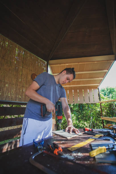 istock Man working like carpenter in his backyard 1266994271