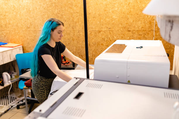 istock Modern young business owner working in her digital printing workshop 1266994531