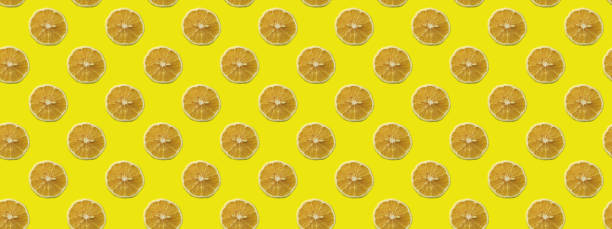 istock Seamless pattern of yellow lemon slices on yellow background. 1266994582